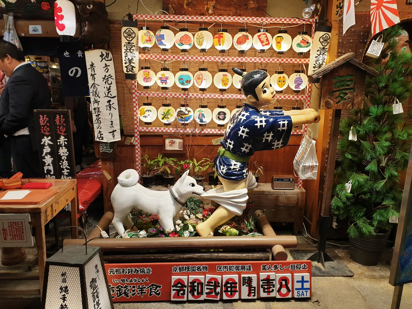 Decorated Kyoto storefront with figures and lanterns