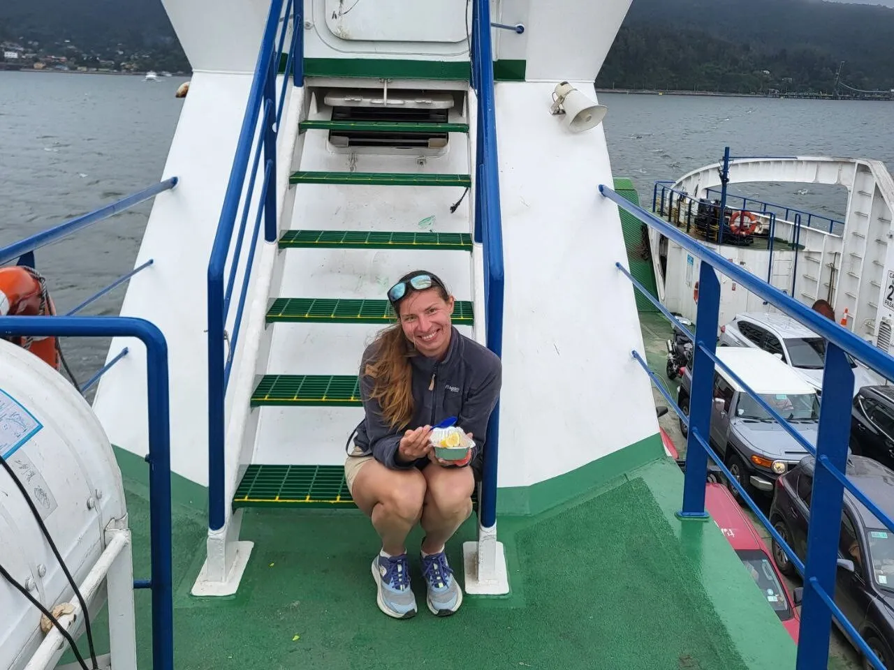 Viajera sentada en los peldaños de una embarcación